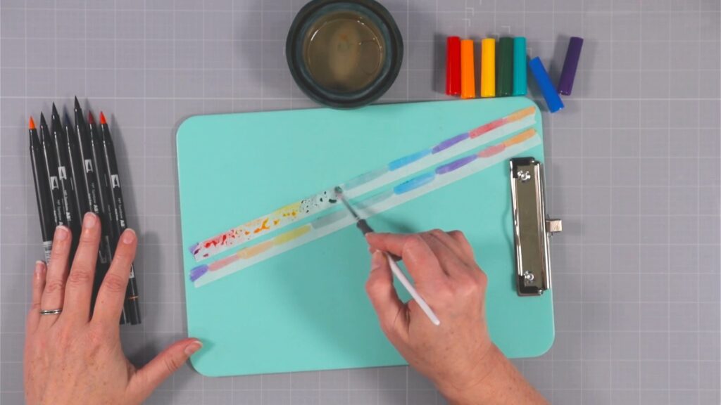 Decorating plain washi tape with watercoloring.